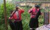 Two ethnic Yao women comb their long hair. As part of their hair care, the Yao women wash with fermented rice water. (Patricia Markby)
