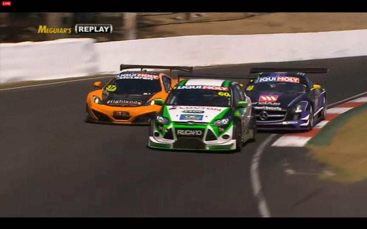 Shane Van Gisengerg in the #37 McLaren tries to use traffic to pass Bernd Schneider in the #1 Mercedes. (bathurst12hour.com.au)