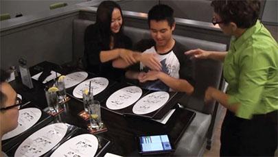 Signs waitstaff teach restaurant patrons to place their order by signing, with help from "cheat sheets" in the menu. (Courtesy Signs Restaurant & Bar)