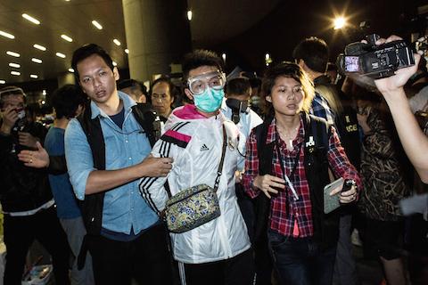 Police detain a man wearing protective as pro-democracy protesters faced-off with police outside the central government offices on November 19, 2014 in Hong Kong. (Lam Yik Fei/Getty Images