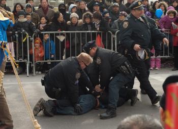 <a href="https://www.theepochtimes.com/assets/uploads/2015/07/Arrest3245_medium.jpg"><img src="https://www.theepochtimes.com/assets/uploads/2015/07/Arrest3245_medium.jpg" alt="DISRUPTION: Police arrest a man who jumped a police barricade and threw himself at the Falun Gong practitioners, breaking a pole of their banner, during the Lunar New Year parade on Feb. 12 in Flushing, Queens. (Joshua Philipp/The Epoch Times)" title="DISRUPTION: Police arrest a man who jumped a police barricade and threw himself at the Falun Gong practitioners, breaking a pole of their banner, during the Lunar New Year parade on Feb. 12 in Flushing, Queens. (Joshua Philipp/The Epoch Times)" width="320" class="size-medium wp-image-120672"/></a>