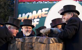 <a href="https://www.theepochtimes.com/assets/uploads/2015/07/Bill_speaks_to_Phil_medium.jpg"><img class="size-medium wp-image-99168" title="Bill Deeley, Punxsutawney Groundhog Club president speaks to Phil himself in Groundhogese, getting this year's winter weather prediction. To his right is Mike Johnston, vice-president, and holding Phil is John Griffiths, one Phil's two handlers. (Jan Jekielek/The Epoch Times)" src="https://www.theepochtimes.com/assets/uploads/2015/07/Bill_speaks_to_Phil_medium.jpg" alt="Bill Deeley, Punxsutawney Groundhog Club president speaks to Phil himself in Groundhogese, getting this year's winter weather prediction. To his right is Mike Johnston, vice-president, and holding Phil is John Griffiths, one Phil's two handlers. (Jan Jekielek/The Epoch Times)" width="320"/></a>