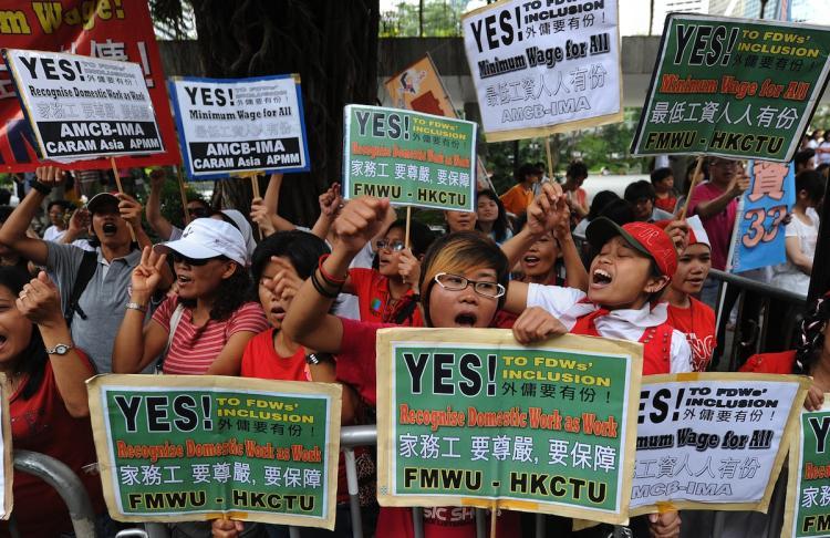 <a><img src="https://www.theepochtimes.com/assets/uploads/2015/09/102876701.jpg" alt="A group of domestic helpers protest for a minimum wage outside the Legislative Council in Hong Kong on July 14. (Mike Clarke/Getty Images)" title="A group of domestic helpers protest for a minimum wage outside the Legislative Council in Hong Kong on July 14. (Mike Clarke/Getty Images)" width="320" class="size-medium wp-image-1815107"/></a>