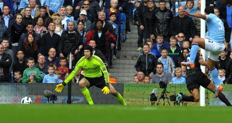 <a><img src="https://www.theepochtimes.com/assets/uploads/2015/09/104440507.jpg" alt="Man City's Argentinian striker Carlos Tevez (R) shoots past Chelsea's Czech goalkeeper Petr Cech to score the only goal of the English Premier League football match at the City Of Manchester Stadium in Manchester, Sept. 25. (Andrew Yates/AFP/Getty Images)" title="Man City's Argentinian striker Carlos Tevez (R) shoots past Chelsea's Czech goalkeeper Petr Cech to score the only goal of the English Premier League football match at the City Of Manchester Stadium in Manchester, Sept. 25. (Andrew Yates/AFP/Getty Images)" width="320" class="size-medium wp-image-1814304"/></a>