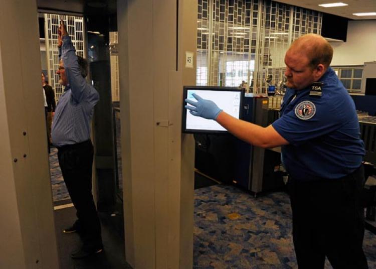 <a><img src="https://www.theepochtimes.com/assets/uploads/2015/09/108703080.jpg" alt="Transportation Security Administration (TSA) employees demonstrate an advanced image technology (AIT) millimeter wave scanner using new Automated Target Recognition software being tested by the TSA at McCarran International Airport February 1, 2011 in Las Vegas, Nevada. (Ethan Miller/Getty Images)" title="Transportation Security Administration (TSA) employees demonstrate an advanced image technology (AIT) millimeter wave scanner using new Automated Target Recognition software being tested by the TSA at McCarran International Airport February 1, 2011 in Las Vegas, Nevada. (Ethan Miller/Getty Images)" width="320" class="size-medium wp-image-1808223"/></a>
