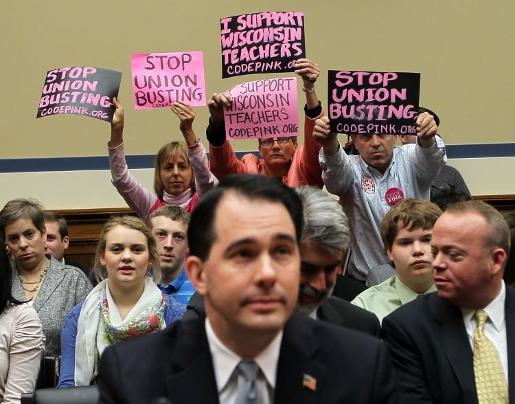 <a><img src="https://www.theepochtimes.com/assets/uploads/2015/09/112183312.jpg" alt="OPPOSITION: Members of Code Pink (L-R) Medea Benjamin, Liz Hourican, and Tighe Barry, protest as Wisconsin Gov. Scott Walker (C) attends the House Oversight and Government Reform Committee April 14 on Capitol Hill in Washington, D.C. (Alex Wong/Getty Images)" title="OPPOSITION: Members of Code Pink (L-R) Medea Benjamin, Liz Hourican, and Tighe Barry, protest as Wisconsin Gov. Scott Walker (C) attends the House Oversight and Government Reform Committee April 14 on Capitol Hill in Washington, D.C. (Alex Wong/Getty Images)" width="320" class="size-medium wp-image-1801219"/></a>