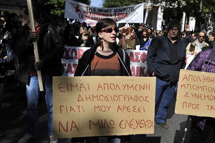 <a><img class="size-large wp-image-1774945" title="A Greek journalist carries a placard during a 24-hour strike on Oct. 18, 2011 in Athens. Greek journalists will go on strike Nov. 6 to Nov. 7 following the suspension of three journalists on Tuesday. " src="https://www.theepochtimes.com/assets/uploads/2015/09/1295315201.jpg" alt="A Greek journalist carries a placard during a 24-hour strike on Oct. 18, 2011 in Athens. Greek journalists will go on strike Nov. 6 to Nov. 7 following the suspension of three journalists on Tuesday. (LOUISA GOULIAMAKI/AFP/Getty Images) " width="590" height="392"/></a>