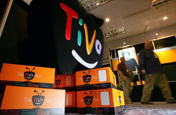 <a><img src="https://www.theepochtimes.com/assets/uploads/2015/09/51921649.jpg" alt=" man walks by a display of TiVo boxes at the 2005 Consumer Electronics Show January 6, 2005 in Las Vegas, Nevada. (Justin Sullivan/Getty Images)" title=" man walks by a display of TiVo boxes at the 2005 Consumer Electronics Show January 6, 2005 in Las Vegas, Nevada. (Justin Sullivan/Getty Images)" width="320" class="size-medium wp-image-1808461"/></a>