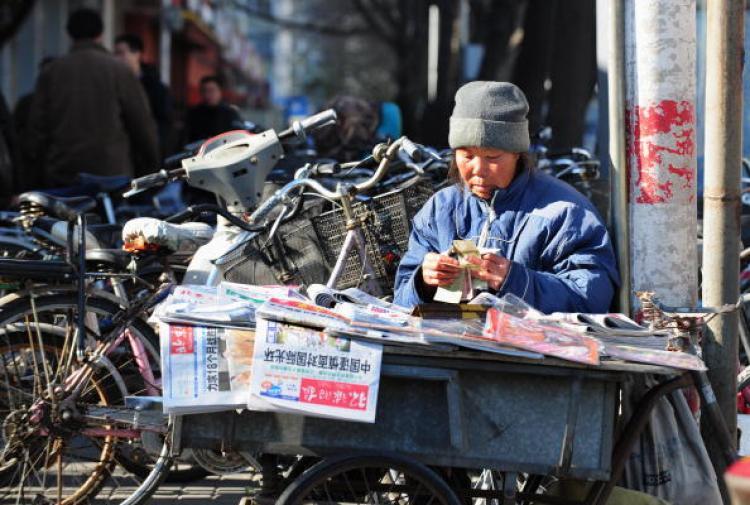 <a><img src="https://www.theepochtimes.com/assets/uploads/2015/09/83811790.jpg" alt="A newspaper vendor counts her one yuan (or RMB) notes in Beijing. (Frederic J Brown/AFP/Getty Images)" title="A newspaper vendor counts her one yuan (or RMB) notes in Beijing. (Frederic J Brown/AFP/Getty Images)" width="320" class="size-medium wp-image-1832666"/></a>