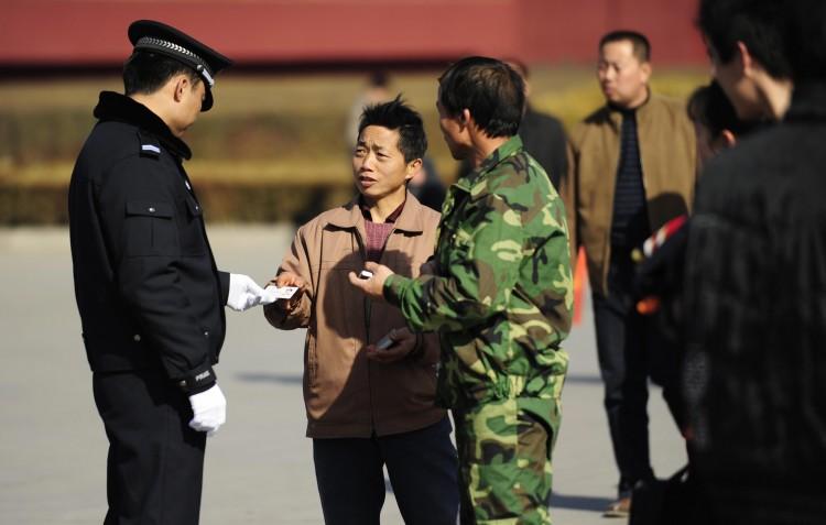 <a><img class="size-medium wp-image-1786635" title="A policeman checks a visitor's ID card at Tiananmen Gate in Beijing on March 1, 2009.      (Peter Parks/AFP/Getty Images)" src="https://www.theepochtimes.com/assets/uploads/2015/09/85163005.jpg" alt="" width="350" height="262"/></a>