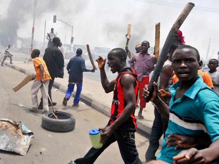 <a><img src="https://www.theepochtimes.com/assets/uploads/2015/09/NIGERIA-112297057-WEB.jpg" alt="Youths hold wooden and metal sticks while running battles broke out between protesters and soldiers in Nigeria's northern city of Kano, on April 18, as President Goodluck Jonathan headed for an election win. (Seyllou Diallo/Getty Images)" title="Youths hold wooden and metal sticks while running battles broke out between protesters and soldiers in Nigeria's northern city of Kano, on April 18, as President Goodluck Jonathan headed for an election win. (Seyllou Diallo/Getty Images)" width="320" class="size-medium wp-image-1805390"/></a>