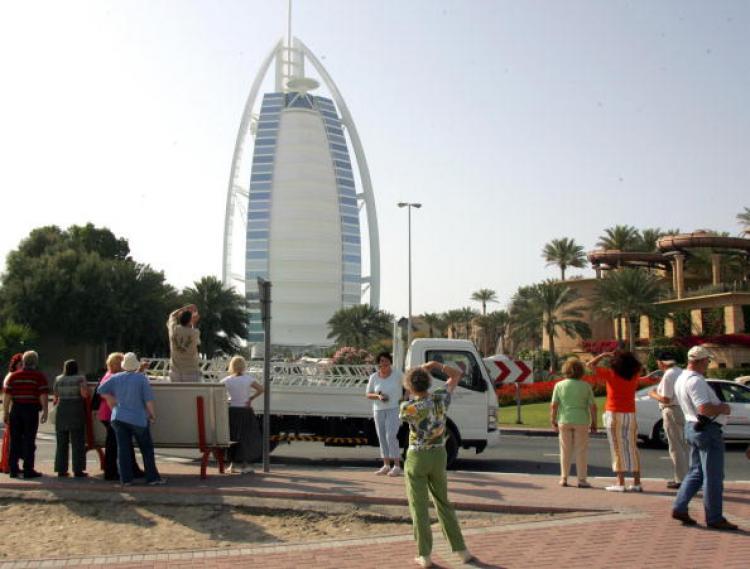 <a><img src="https://www.theepochtimes.com/assets/uploads/2015/09/dub52701428.jpg" alt="European tourists take pictures of the Burj al-Arab (L) and Jumeirah Beach Hotel in Dubai. (Rabih Moghrabi)" title="European tourists take pictures of the Burj al-Arab (L) and Jumeirah Beach Hotel in Dubai. (Rabih Moghrabi)" width="320" class="size-medium wp-image-1834787"/></a>