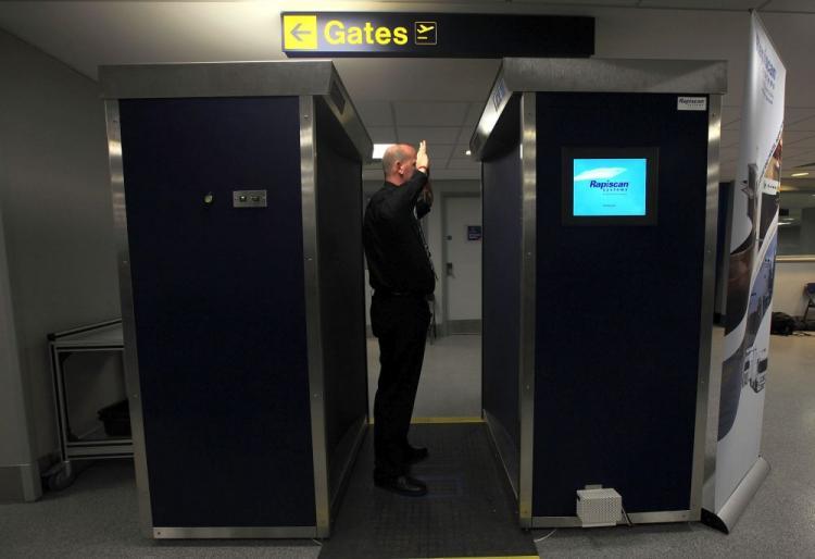 <a><img src="https://www.theepochtimes.com/assets/uploads/2015/09/scanner95622279.jpg" alt="A security officer demonstrates the new full body scanning machine on trial at Manchester Airport on January 7, 2010 in Manchester, England. Last month, ExpressJet pilot Michael Roberts was sent home after refusing the scan and an enhanced pat down. (Christopher Furlong/Getty Images)" title="A security officer demonstrates the new full body scanning machine on trial at Manchester Airport on January 7, 2010 in Manchester, England. Last month, ExpressJet pilot Michael Roberts was sent home after refusing the scan and an enhanced pat down. (Christopher Furlong/Getty Images)" width="320" class="size-medium wp-image-1812008"/></a>