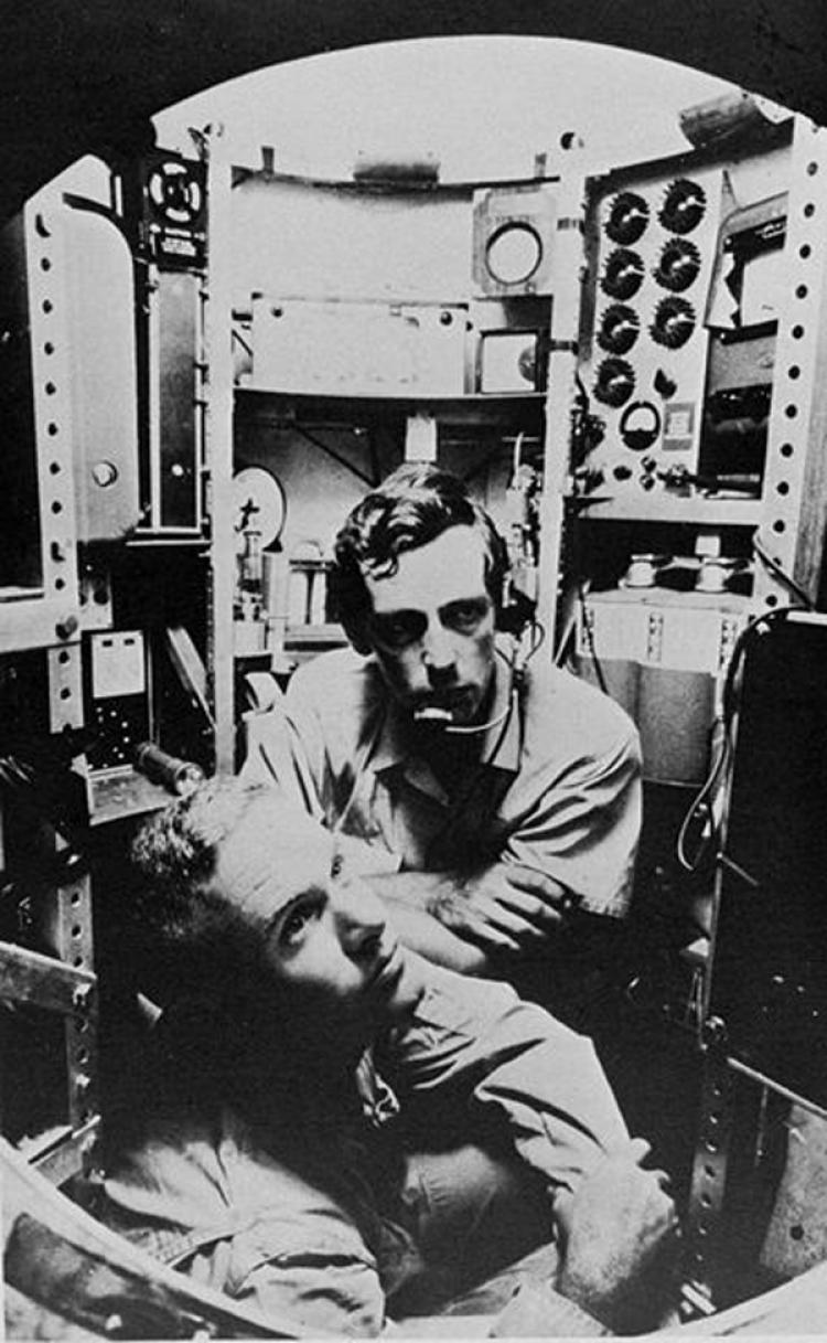 HISTORIC SUB: The Bathyscaphe Trieste is hoisted out of the water in a tropical port, circa 1958-59, soon after it was purchased by the U.S. Navy. The submarine would later make a journey to the deepest known part of the ocean. (U.S. Naval Historica)