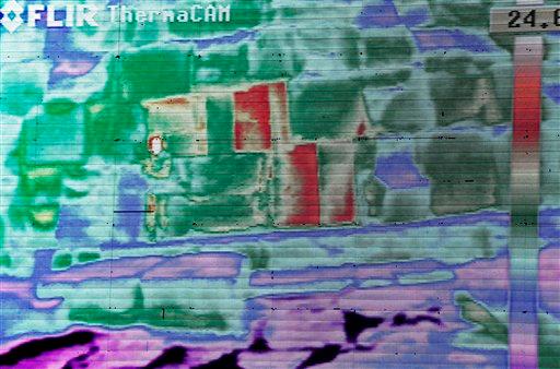 Live footage from a thermal camera of limestone blocks from the Khufu pyramid are displayed showing different colors representing varying temperatures during a press conference, in Giza, Egypt, Monday, Nov. 9, 2015. (AP Photo/Nariman El-Mofty)