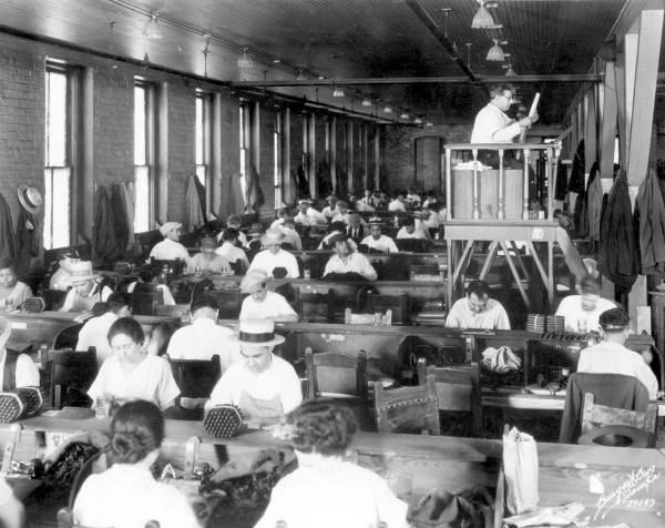 Lector reading at Cuesta Rey cigar company. (Burgert Brothers. Burgert's Studio - Tampa, Florida)