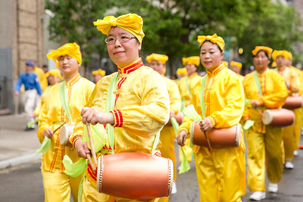 A Falun Gong waist drum troupe performs in the World Falun Dafa Day parade along 42nd Street in New York, on May 13, 2016. (Samira Bouaou/Epoch Times)