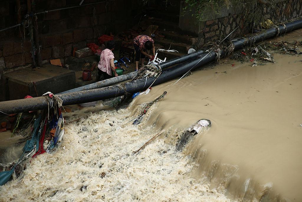 Residents clean furniture by a river in Bandong Town after Typhoon Nepartak on July 10, 2016 in Minqing County, Fujian Province. (VCG/VCG via Getty Images)