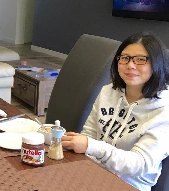 Ms Rabee enjoying a Western style snack, in Brisbane, during August 2016. (Linda Huang/NTD Television)