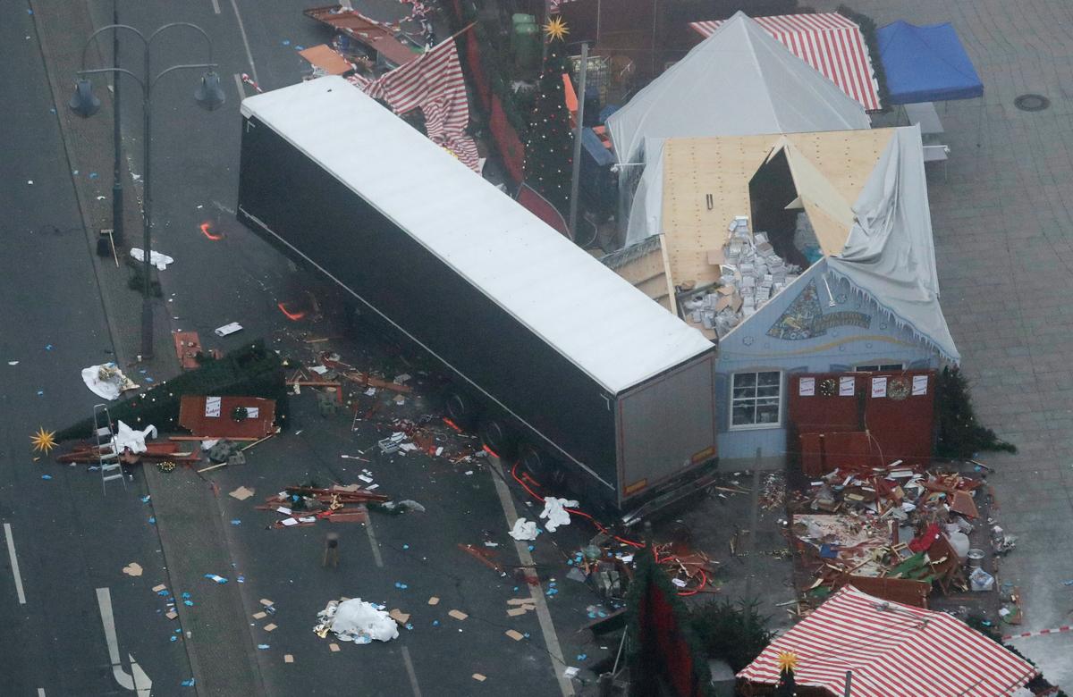 The trailer of a truck stands beside destroyed Christmas market huts in Berlin, Germany on Dec. 20, 2016. (AP Photo/Markus Schreiber)