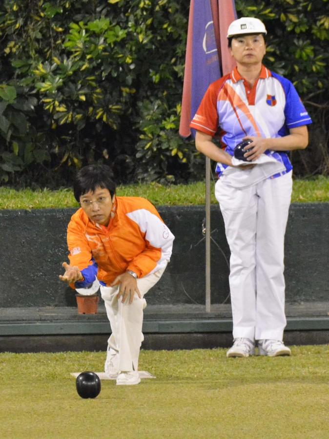 In a battle between two experienced bowlers, Queenie Lai (delivering) from Seabird Sports Association defeated Amy Chwang from Kowloon Bowling Green Club at final of the National Knock-out Singles on Sunday night (Dec 18, 2016). (Stephanie Worth)