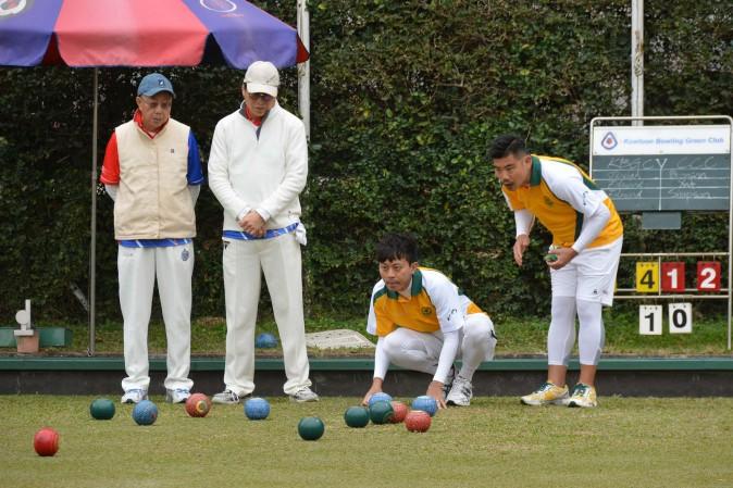 Wong Chun Yat and Bronson Fung of CCC-A closely watch their skip Simpson Chang's wood enter the head in the Triples League match against KBGC-B on Sat Jan 14, 2017. Chang's rink won easily, 23 to 4, to take 2 points and also provided the aggregate score of 2 points to CCC. (Stephanie Worth)
