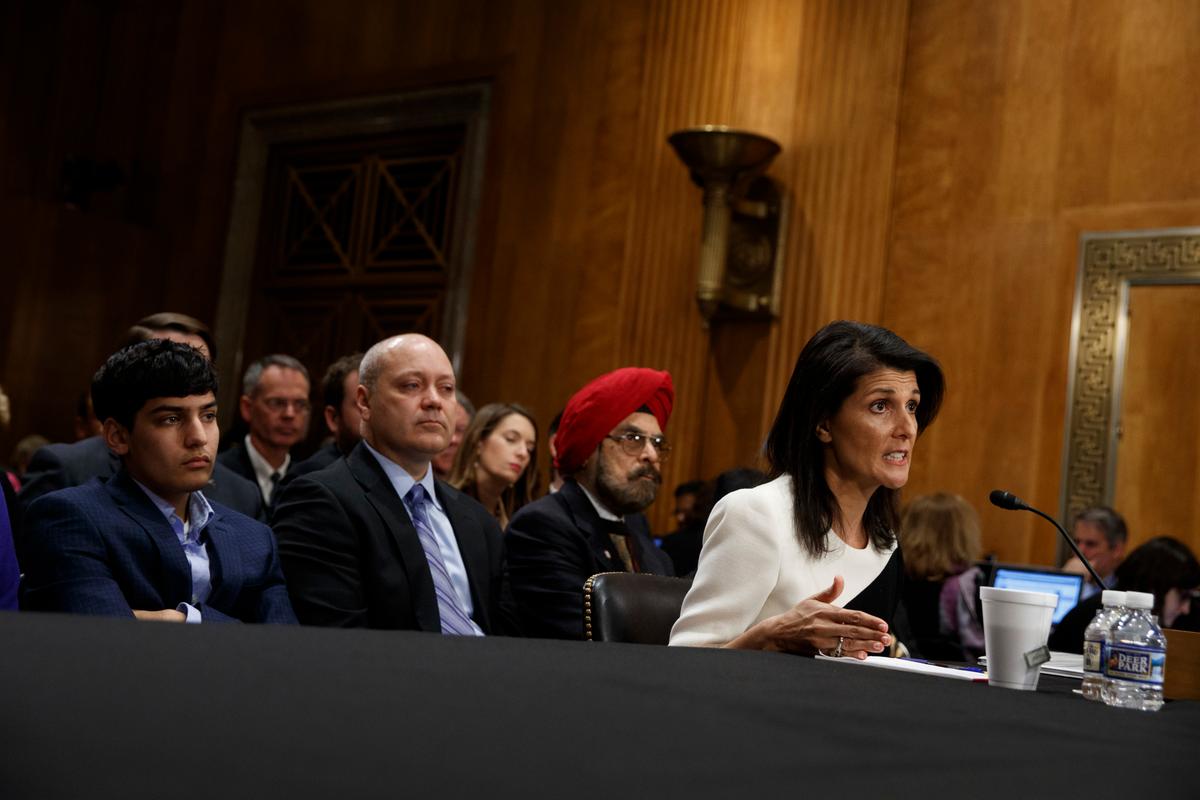 UN Ambassador-designate Gov. Nikki Haley, accompanied by her family (L-R) Nalin Haley, husband Michael Haley and father Dr. Ajit Singh Randhawa, testifies on Capitol Hill in Washington on Jan. 18, 2017. (AP Photo/Evan Vucci)