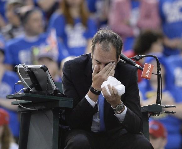 Umpire Arnaud Gabas of France holds his face after being hit by a ball from Canada's Denis Shapovalov in a match against Great Britain's Kyle Edmund on Feb. 5, 2017 in Ottawa. (The Canadian Press/Justin Tang)