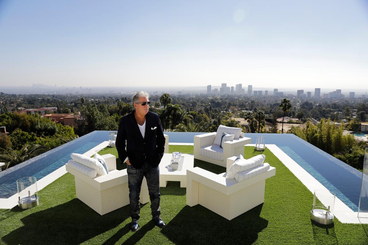 Developer Bruce Makowsky poses for a photo on the balcony off the master bedroom of a $250 million mansion he built in the Bel-Air area of Los Angeles. (AP Photo/Jae C. Hong)