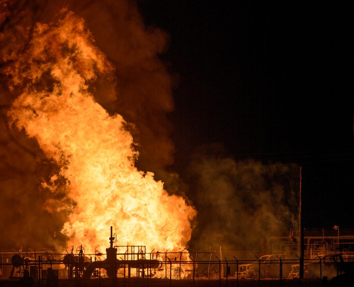 Vehicles and a power pole smoke next to a fire at the Phillips 66 pipeline in Paradis, La., on Feb. 9, 2017. (Matthew Hinton/The Advocate via AP)