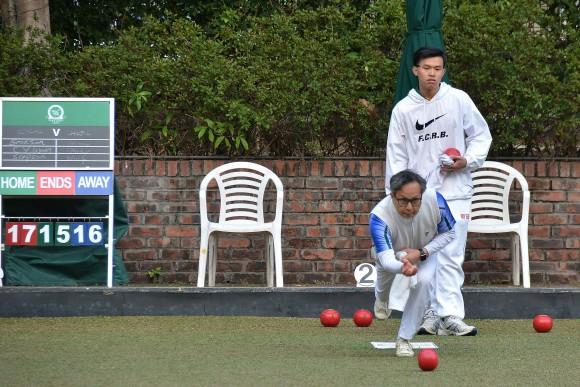 Wing Chan (delivering) of Hong Kong Football Club tried to dislodge CCC's shot in the last end of his game against youngster Simpson Cheung 18 in the HKLBA Triples League on Saturday Feb 11, 2017. Chan missed all three shots and lost the game 19-16 and CCC won with an overall result of 6:2. (Stephanie Worth)