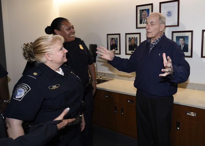 Secretary of Homeland Security John Kelly, right, talks with with U.S. Customs and Border Protection officers before a meeting held at the San Isidro Port of Entry, Friday, Feb. 10, 2017, in San Diego. (AP Photo/Denis Poroy, Pool)
