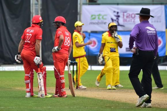 Misbah Ul-Haq and Ehsan Khan of HKI confer during their final league game against City Kaitak in the T20 Blitz in Hong Kong on Sunday March 12, 2017. (Bill Cox/Epoch Times)