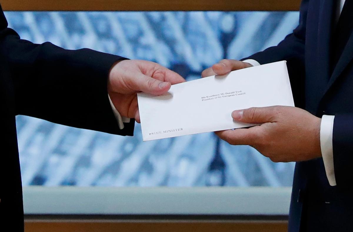 Britain's permanent representative to the European Union Tim Barrow delivers British Prime Minister Theresa May's Brexit letter in notice of the UK's intention to leave the bloc under Article 50 of the EU's Lisbon Treaty to EU Council President Donald Tusk in Brussels, Belgium on March 29, 2017. (REUTERS/Yves Herman)