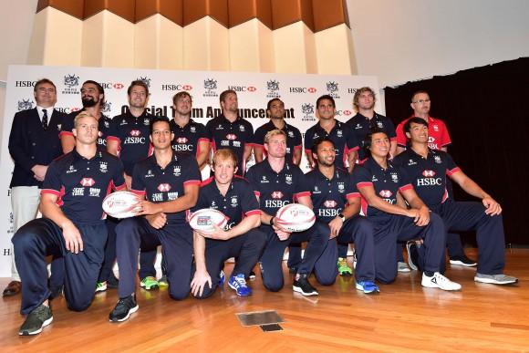 Hong Kong Men's squad: together with (L) Robbie McRobbie Deputy CEO of the HKRU, and (R) coach Paul John: Team back Row (L-R): Michael Coverdale, Ryan Meacheam, Tom McQueen, Lee Jones, Ben Rimene, Rowan Varty, Mark Wright, Paul John (coach). Front Row: Max Woodward (Capt), Chris Maize, Toby Fenn, Jamie Hood, Jason Jeyam, Cado Lee Ka-to, Salom Yiu Kam-shing. (Bill Cox/Epoch Times)