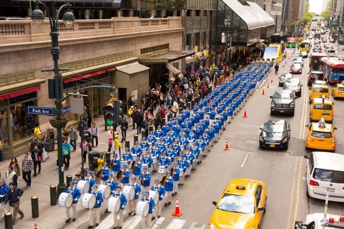 The Divine Land Marching Band marches in a parade along 42nd Street in New York for World Falun Dafa Day on May 12, 2017. (Evan Ning/The Epoch Times)