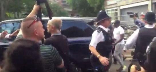 British Prime Minister Theresa May is barracked while she is bundled into her car, as she visits an emergency centre close to the scene of the Grenfell Tower fire, in north Kensington, West London, Britain, in this picture filmed by 5 News producer Rachel Lucas and obtained on June 16, 2017 on social media. (Social media via REUTERS/Courtesy ÒRACHEL LUCAS / 5 NEWSÓ)
