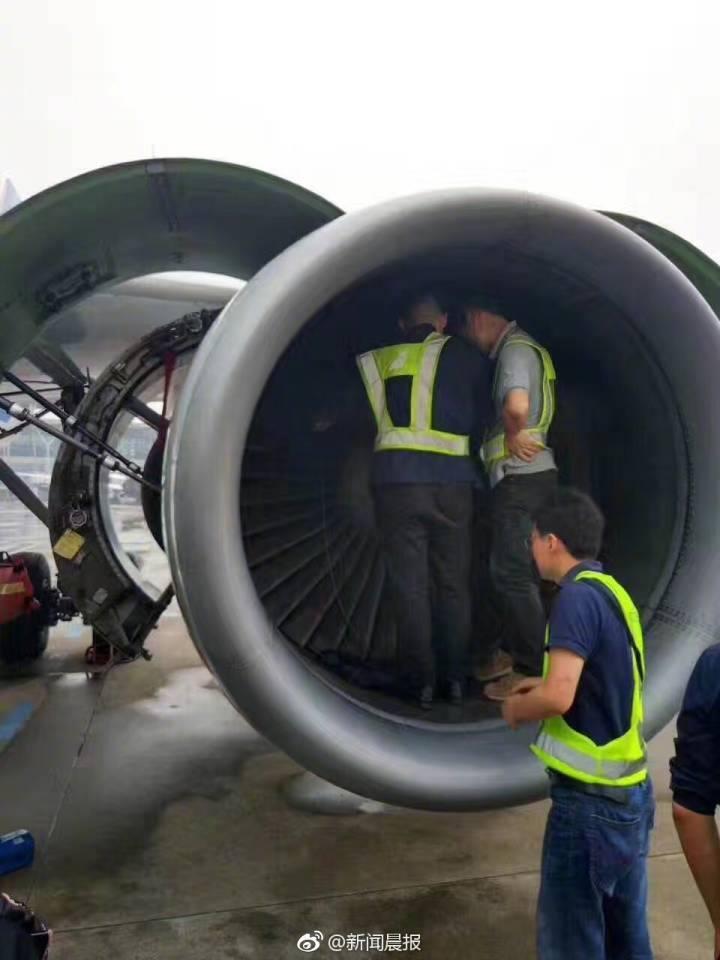 Aircraft maintenance staff inspect the engine of an Airbus A320 jet for coins.