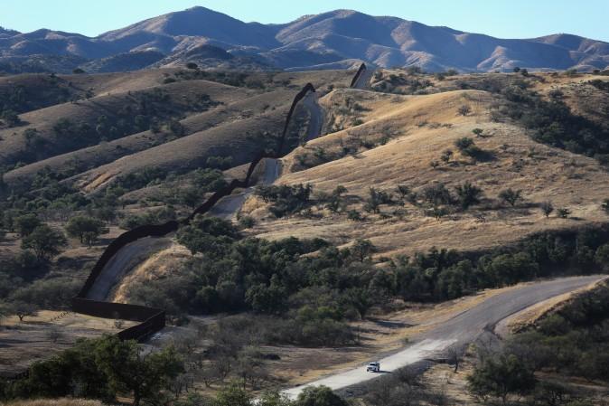 A U.S. Border Patrol vehicle drives along the U.S.-Mexico border fence on Dec. 9, 2014 near Nogales, Arizona. (John Moore/Getty Images)