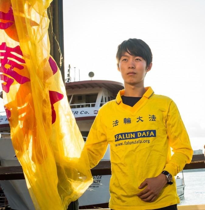 Collin Ding joins other Falun Gong practitioners for a rally and a candlelight vigil in front of the Chinese Consulate in New York on July 16, 2017. Ding said he was there to peacefully protest the continued persecution of his beliefs. (Benjamin Chasteen/The Epoch Times)