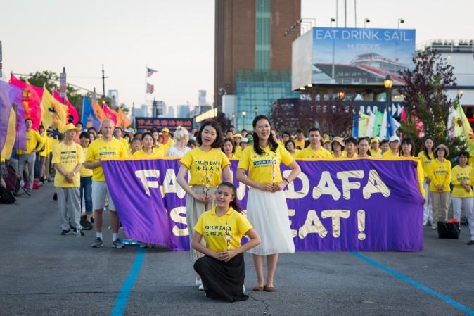 Women perform a song and dance at a rally in front of the Chinese Consulate in New York calling for an end to the Falun Gong persecution inside China in New York on July 16, 2017. (Benjamin Chasteen/The Epoch Times)