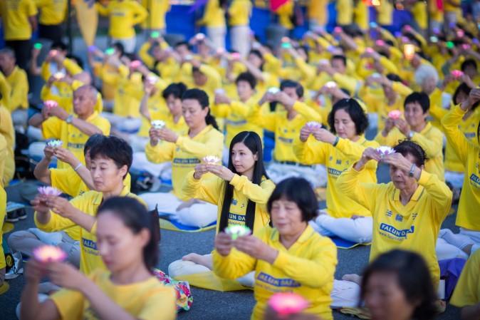 Hundreds of Falun Gong practitioners and supporters hold a candlelight vigil in front of the Chinese Consulate in New York on July 16, 2017. Launched on July 20, 1999, the persecution is now entering its 18th year inside China. (Benjamin Chasteen/The Epoch Times)