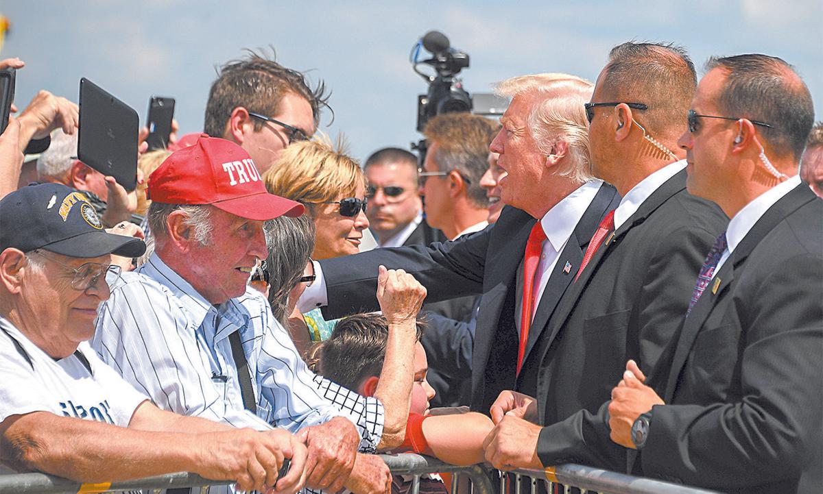 President Donald Trump greets supporters as he arrives in Springfield, Mo., on Aug. 30. (JIM WATSON/AFP/GETTY IMAGES)