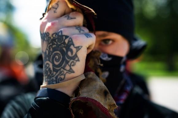 A man belonging to the Antifa extremist organization holds up the remains of a burned US flag in Colorado on June 10, 2017. (JASON CONNOLLY/AFP/Getty Images)
