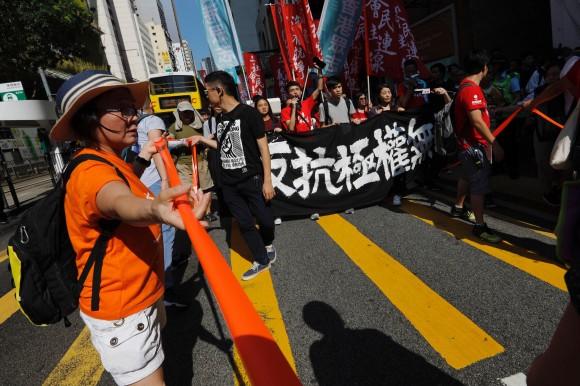 Demonstrators march in protest of the jailing of student leaders Joshua Wong, Nathan Law and Alex Chow in Hong Kong China August 20, 2017. Words on banner read: "Not a crime to go against totalitarianism." (Reuters/Tyrone Siu)