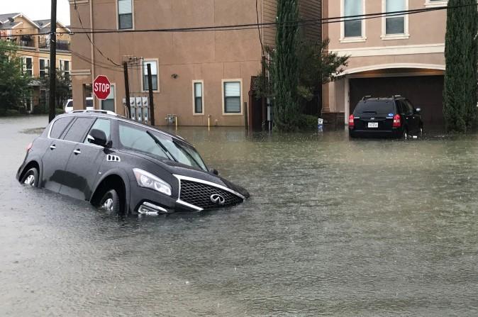 A vehicle sits half submerged in flood waters in a residential area in the aftermath of Hurricane Harvey in Houston, Texas, U.S. on Aug. 27, 2017. (REUTERS/Ernest Scheyder)