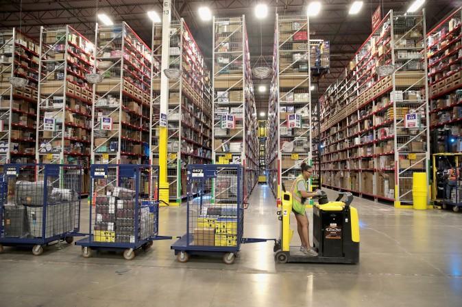 A Worker packs and ships customer orders at the 750,000-square-foot Amazon fulfillment center in Romeoville, Ill., on Aug. 1. (Scott Olson/Getty Images)