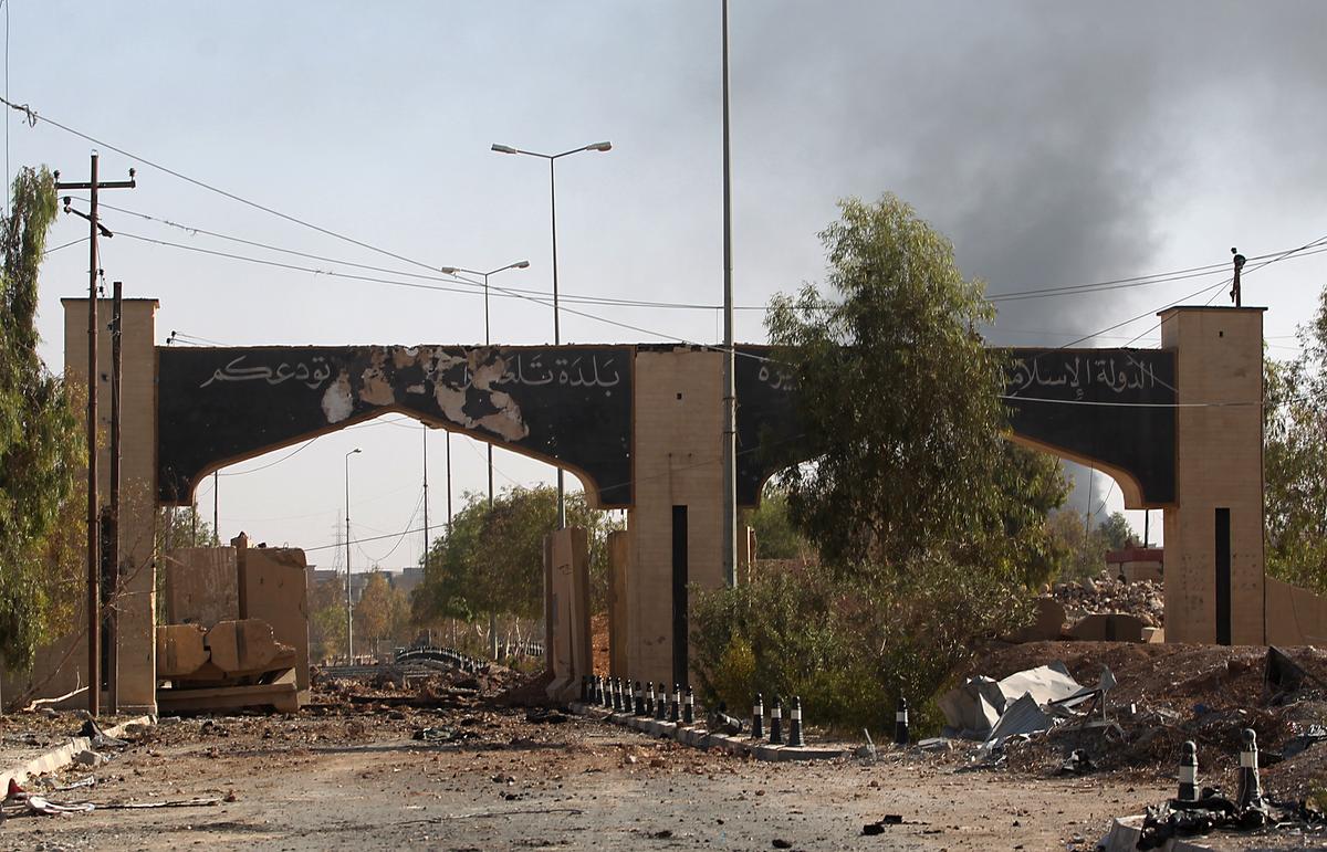 The gate at the entrance of Tal Afar, Iraq, covered in writing from ISIS on Aug. 30, 2017. Terrorists inside Tal Afar were believed to have fled to Al-Ayadieh, located on the road between the city and the Syrian border, where they appeared to be making a desperate last stand. (AHMAD AL-RUBAYE/AFP/Getty Images)