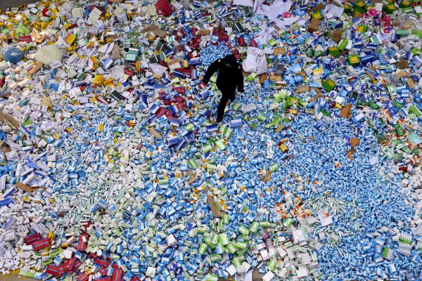 This photo taken on March 14 shows a Chinese policeman crossing a stack of fake drugs seized in Beijing in recent months. The rapid growth of Internet commerce has led to an explosion of counterfeit medicines sold around the world, with China being the largest source of fake medicines, pharmaceutical experts said, with the illicit trade now accounting for about US $ 75 billion, with criminal gangs. using more and more the Web to move their products across borders. (STR / AFP / Getty Images)