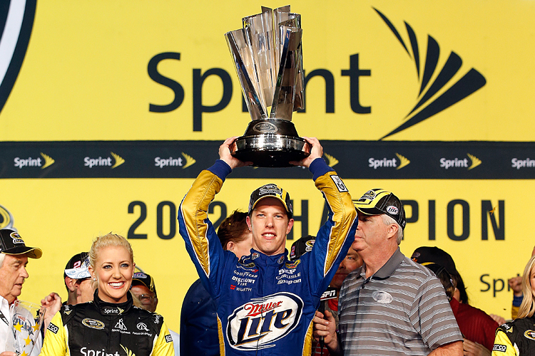 Brad Keselowski, driver of the No. 2 Penske Miller Lite Dodge, hoists the Sprint Cup trophy in Champions Victory Lane after winning the championship and finishing fifteenth place in the NASCAR Sprint Cup Ford EcoBoost 400 at Homestead-Miami Speedway on November 18. (Chris Graythen/Getty Images)